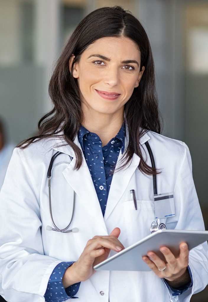 Doctor holding digital tablet at meeting room