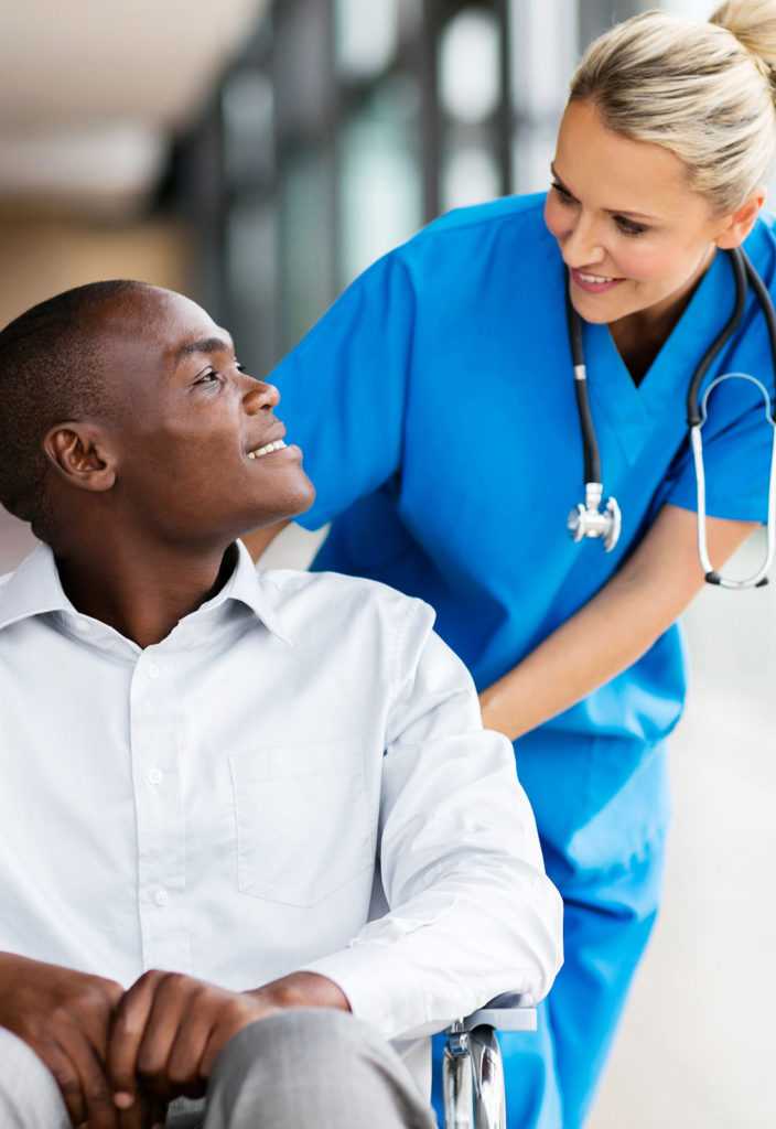 Female nurse talking to disabled patient